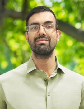 Armando stand up in the nature with beard headshot