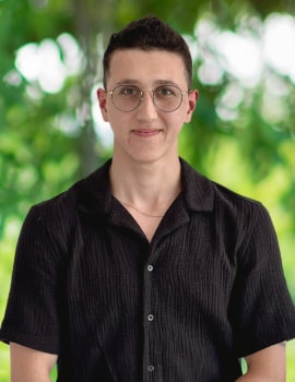 Yahir in the nature wearing black t-shirt looking at the camera with a smile